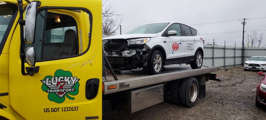 Matt's yellow Lucky 7 flatbed loaded with a AAA-dispatched vehicle